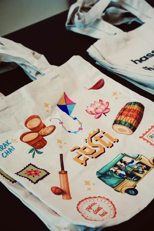 Printed Dosti tote bags photographed on a table